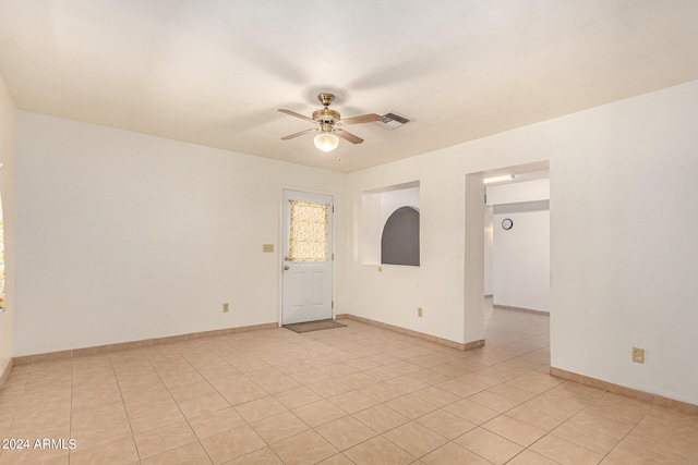 spare room with ceiling fan and light tile patterned flooring