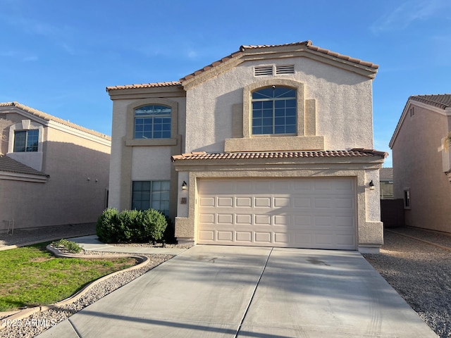 mediterranean / spanish-style home featuring driveway, a tiled roof, stucco siding, and a garage