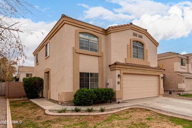 view of front of house with stucco siding, driveway, and a tiled roof