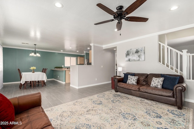 living area featuring stairway, baseboards, recessed lighting, ornamental molding, and ceiling fan with notable chandelier