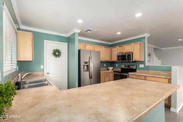 kitchen with appliances with stainless steel finishes, visible vents, a peninsula, and a sink