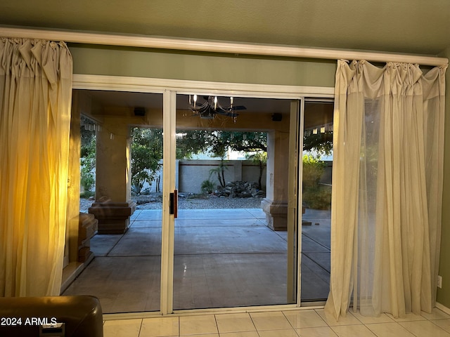 doorway to outside with tile patterned floors