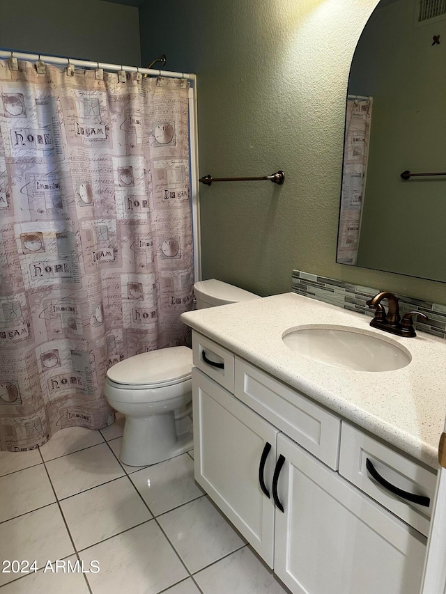 bathroom with tile patterned flooring, vanity, toilet, and a shower with shower curtain