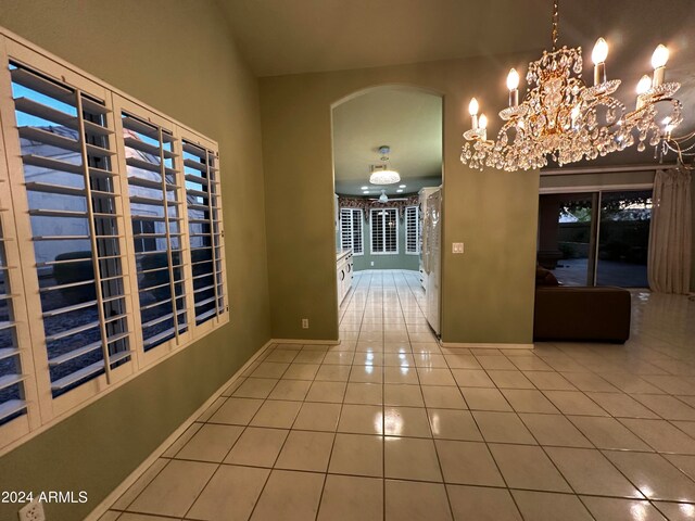 corridor with a chandelier and tile patterned floors