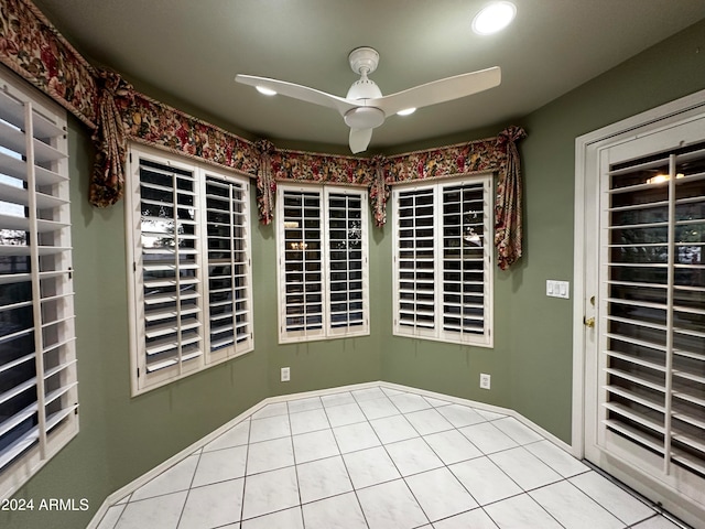 spare room featuring ceiling fan and light tile patterned floors