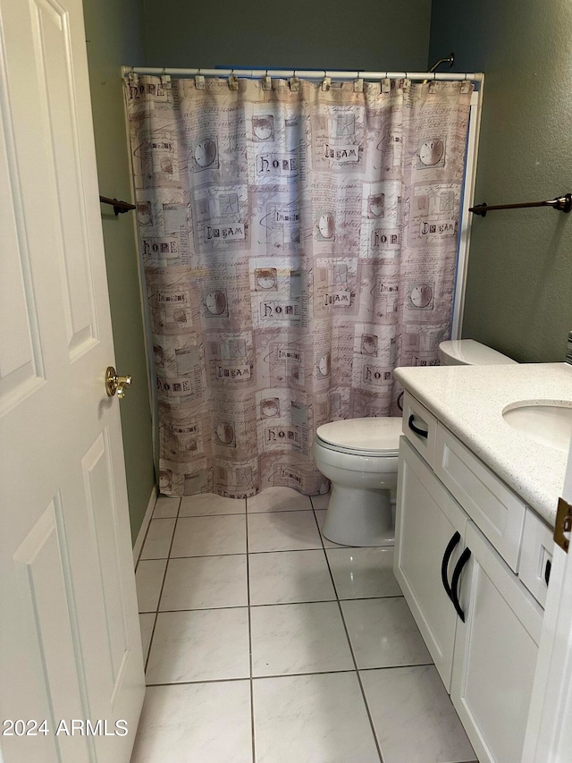 bathroom with tile patterned floors, walk in shower, vanity, and toilet