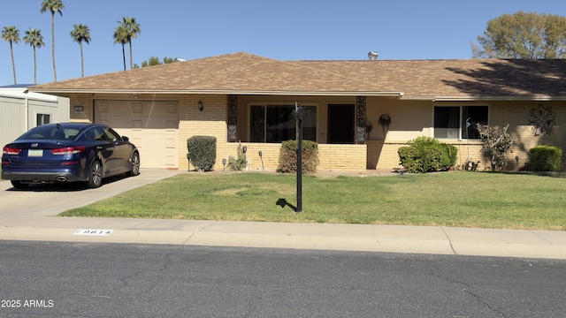 ranch-style home featuring roof with shingles, concrete driveway, an attached garage, a front yard, and brick siding