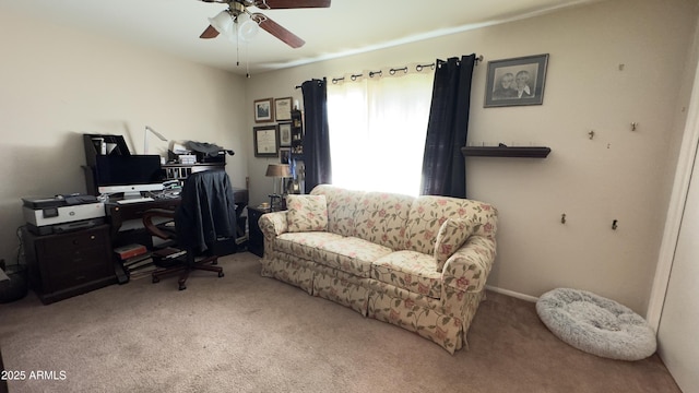 carpeted office space featuring ceiling fan