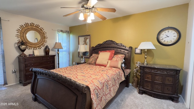 bedroom featuring baseboards, light colored carpet, and a ceiling fan