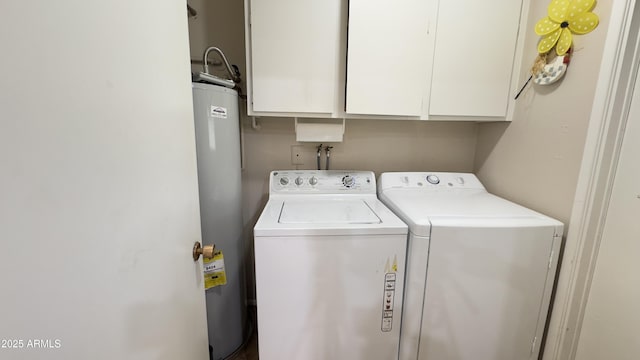 washroom featuring cabinet space, water heater, and washing machine and clothes dryer