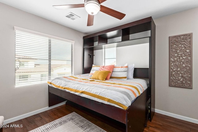 2511 W Queen Creek Rd Unit 425, Chandler, AZ 85248 - bedroom with baseboards, visible vents, wood finished floors, and a ceiling fan