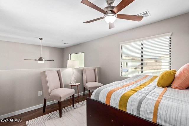 2511 W Queen Creek Rd Unit 425, Chandler, AZ 85248 - bedroom with baseboards, visible vents, a ceiling fan, and wood finished floors