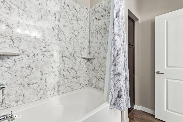 2511 W Queen Creek Rd Unit 425, Chandler, AZ 85248 - full bath with baseboards, wood finished floors, and washtub / shower combination