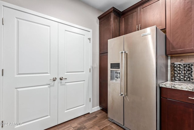 2511 W Queen Creek Rd Unit 425, Chandler, AZ 85248 - kitchen with high end fridge, decorative backsplash, light stone counters, dark brown cabinets, and wood finished floors