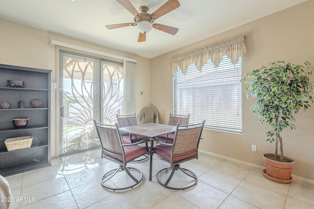 dining area with ceiling fan, baseboards, and light tile patterned floors