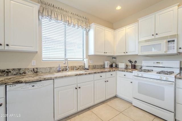 kitchen featuring white appliances, light tile patterned flooring, white cabinetry, a sink, and recessed lighting