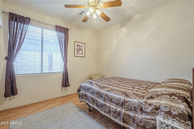 bedroom with a ceiling fan and wood finished floors