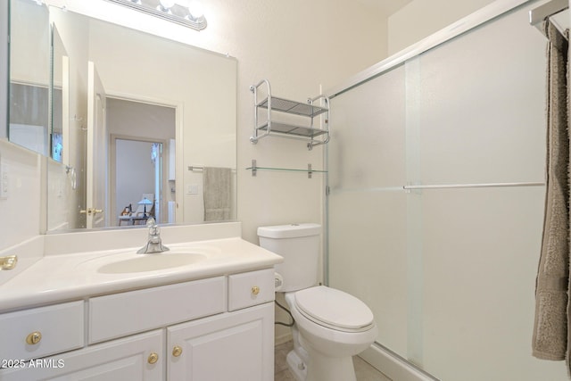 full bathroom featuring a shower stall, toilet, and vanity