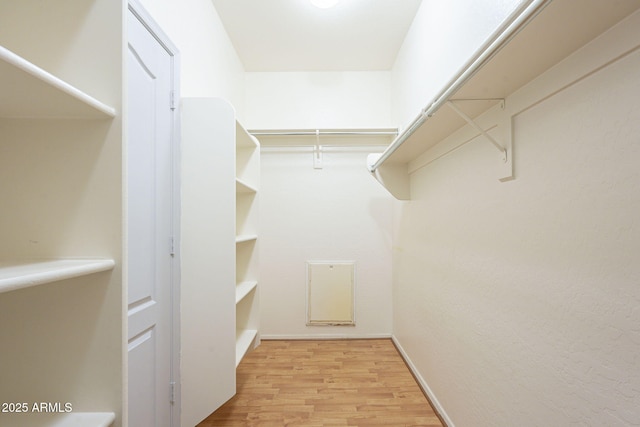 walk in closet featuring light wood finished floors