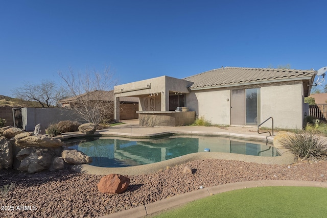 view of pool with fence, outdoor dry bar, a fenced in pool, and a patio