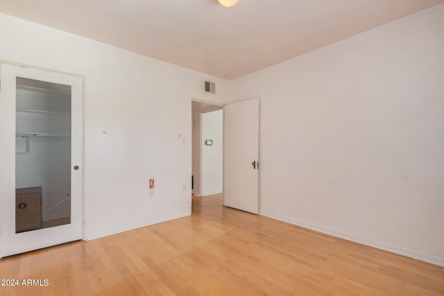 unfurnished bedroom with a closet and light hardwood / wood-style floors