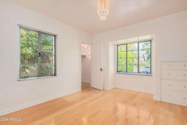 interior space with light hardwood / wood-style flooring and an inviting chandelier