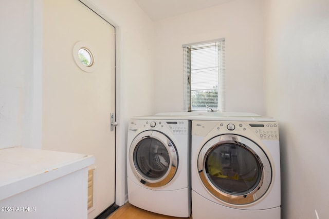 laundry room featuring light hardwood / wood-style flooring and washer and clothes dryer