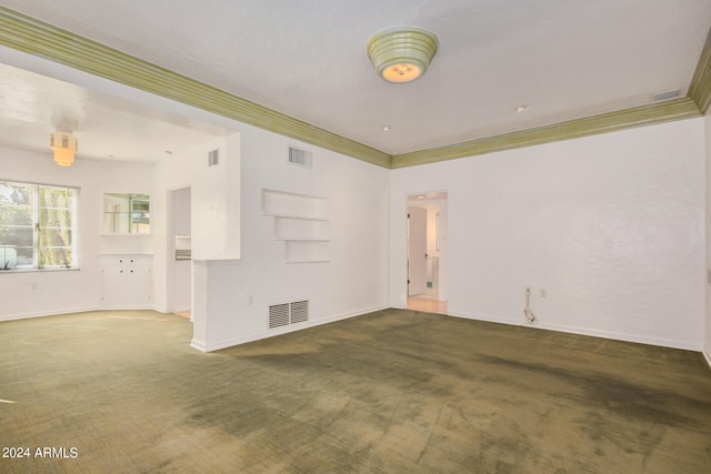 carpeted spare room with crown molding