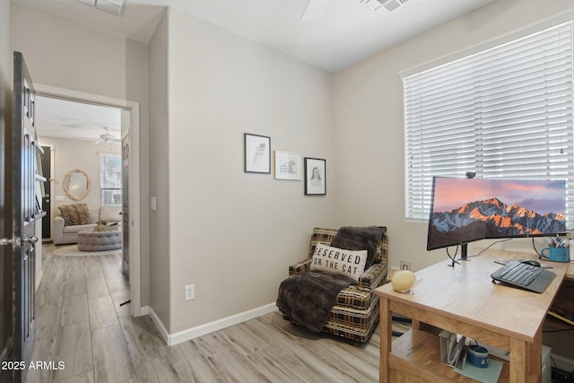 office with a ceiling fan, baseboards, visible vents, and light wood finished floors