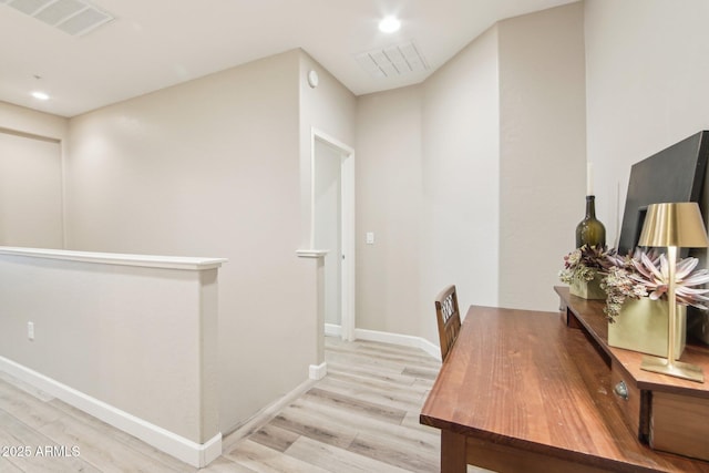 office area featuring light wood-style floors, recessed lighting, visible vents, and baseboards