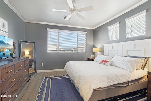 bedroom featuring light wood-type flooring, multiple windows, and crown molding