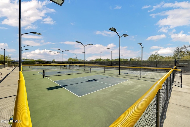 view of tennis court featuring fence