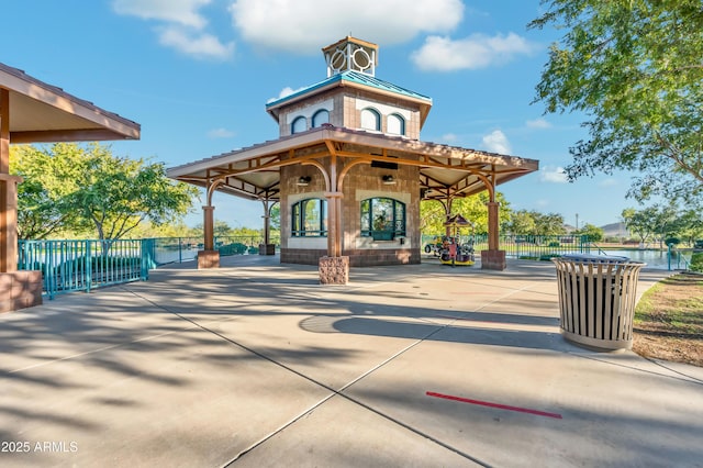 surrounding community with a patio area and fence