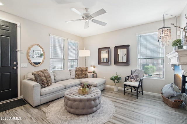 living area featuring light wood finished floors, a wealth of natural light, and baseboards