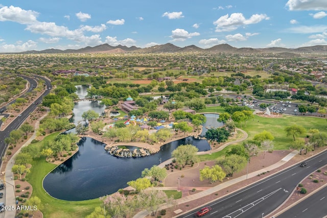 birds eye view of property with a water and mountain view