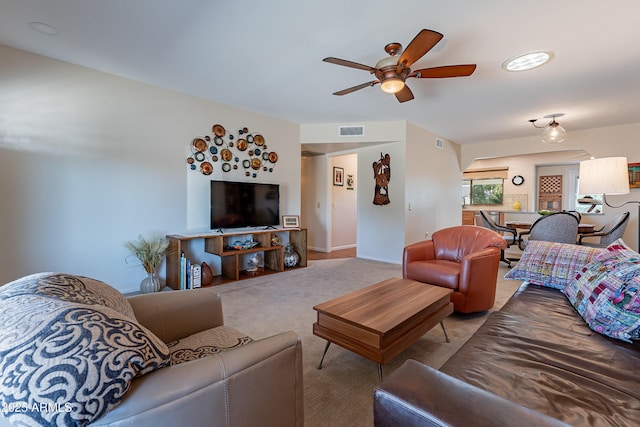 living room featuring ceiling fan and light colored carpet