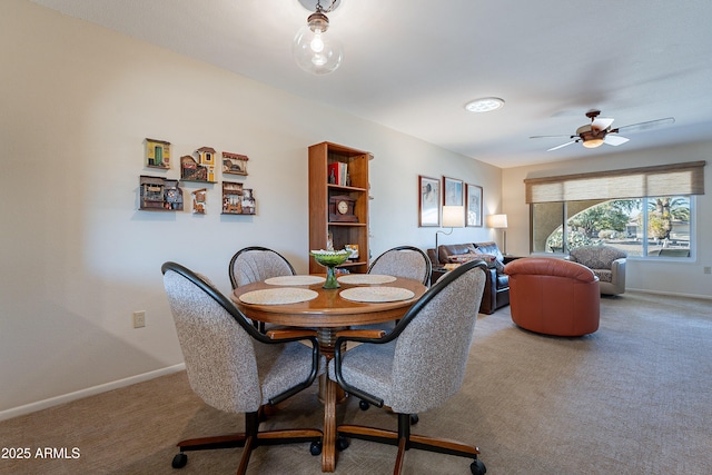 dining area featuring carpet floors and ceiling fan