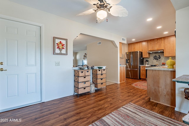 kitchen with tasteful backsplash, stainless steel refrigerator with ice dispenser, dark hardwood / wood-style floors, and ceiling fan