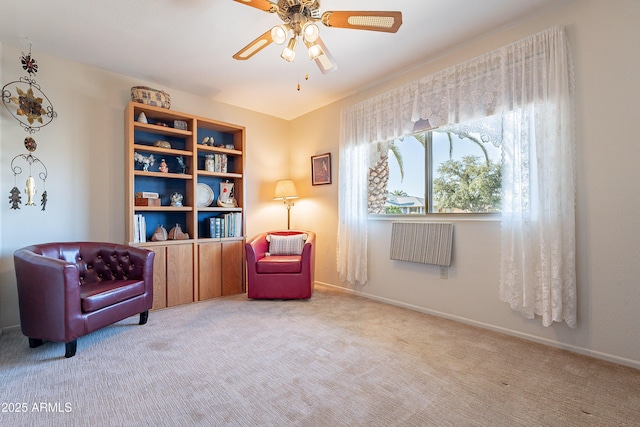 living area with light colored carpet and ceiling fan