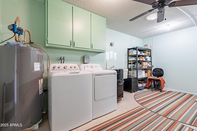 clothes washing area with cabinets, a textured ceiling, ceiling fan, washing machine and dryer, and water heater