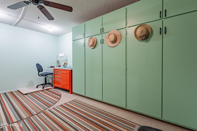 office featuring light tile patterned floors, a textured ceiling, and ceiling fan