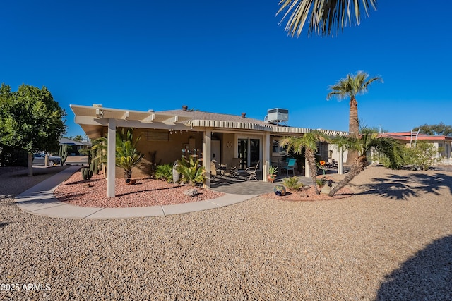 rear view of property with central AC and a patio area