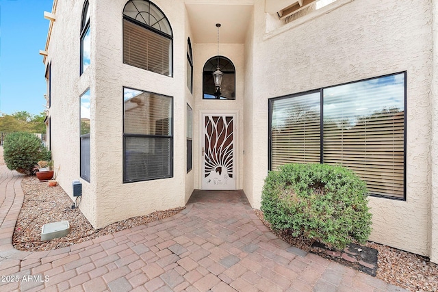 property entrance with stucco siding