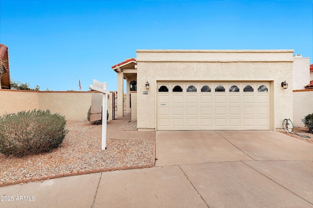 exterior space with a tile roof, concrete driveway, a garage, and stucco siding