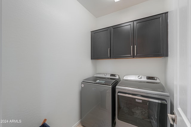 laundry area featuring cabinets and separate washer and dryer