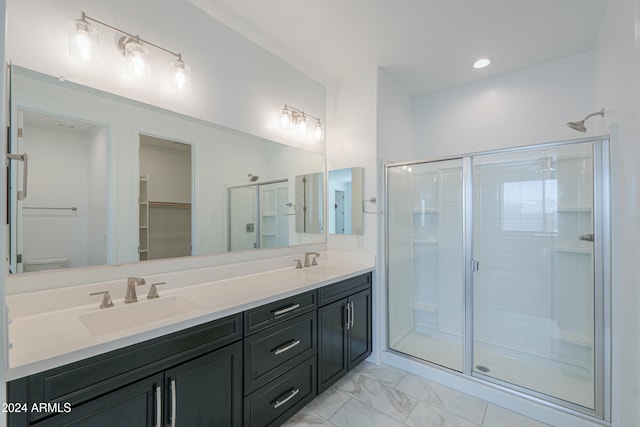 bathroom featuring vanity, toilet, and a shower with door