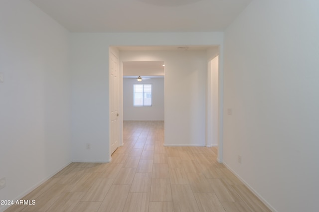 hallway with light hardwood / wood-style floors