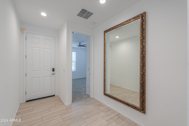 hallway with light colored carpet