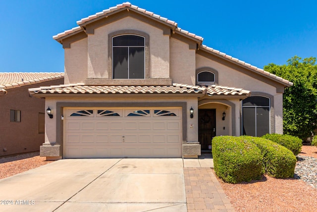 mediterranean / spanish home featuring a garage