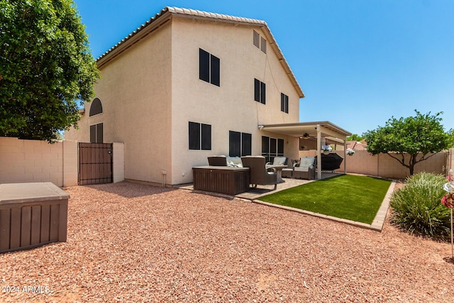 rear view of house featuring a patio area, outdoor lounge area, and ceiling fan